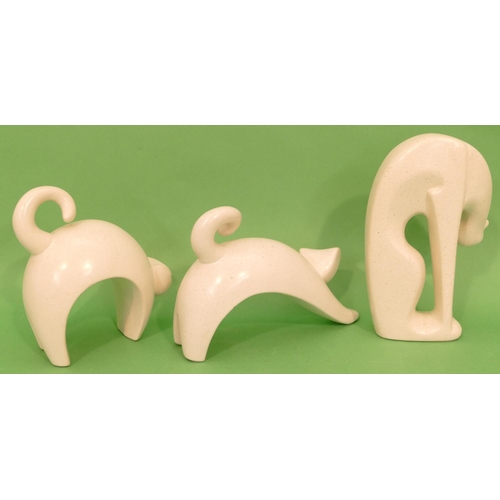 64 - 3 x Earthenware Figures of cats in various poses, on cream ground, tallest 22.5cm high (3).