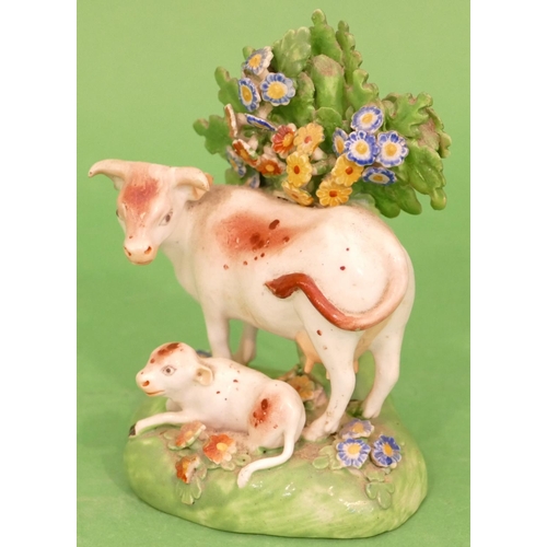 76 - A 19th Century Staffordshire Group of cow and calf with all over encrusted floral decoration, 12.5cm... 