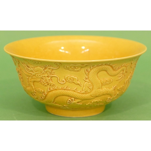 87 - An Oriental Round Trumpet Shaped Bowl on yellow ground having raised dragon decoration, 16cm diamete... 