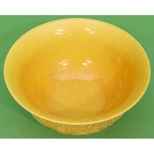 87 - An Oriental Round Trumpet Shaped Bowl on yellow ground having raised dragon decoration, 16cm diamete... 