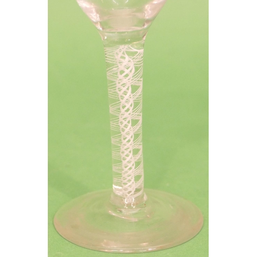 146 - A Georgian Round Cordial Glass having inner opaque twist stem on round sweeping foot, 14cm high.