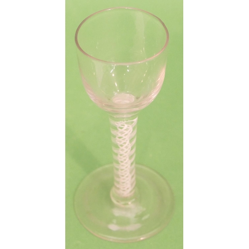 146 - A Georgian Round Cordial Glass having inner opaque twist stem on round sweeping foot, 14cm high.