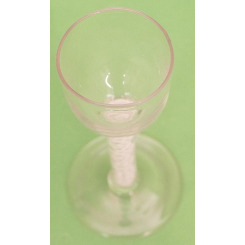 146 - A Georgian Round Cordial Glass having inner opaque twist stem on round sweeping foot, 14cm high.