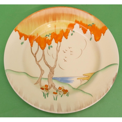 150 - A Clarice Cliff Round Plate depicting colourful tree with cliff and landscape in distance, 25.7cm di... 