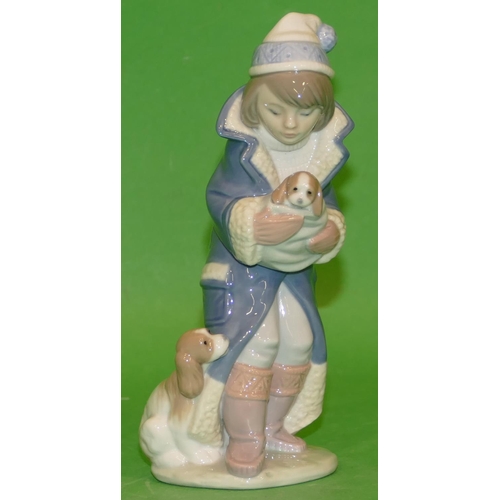 158 - A Lladro Figure of a young girl holding a puppy, 18cm high.