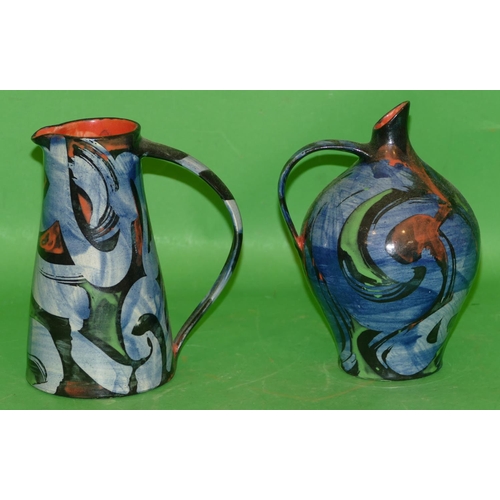 167 - An Art Deco Style Glazed Earthenware Jug on blue and black ground having green and red decoration, i... 