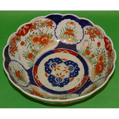 219 - An Imari Round Scallop Shaped Bowl on white, red and blue ground having all over floral, leaf and tr... 