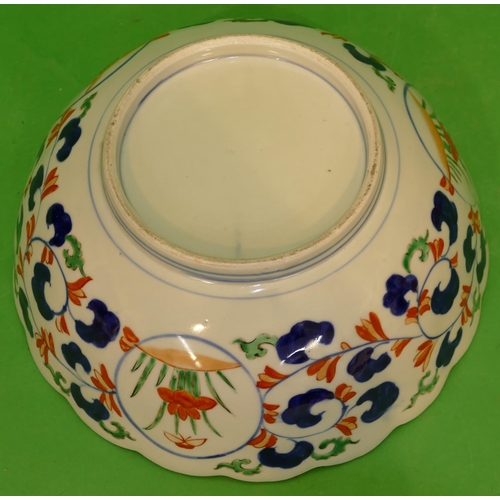 219 - An Imari Round Scallop Shaped Bowl on white, red and blue ground having all over floral, leaf and tr... 