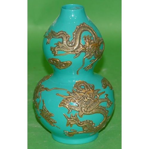 220 - An Oriental Gourd Vase on green ground having raised gilt dragon decoration, 17cm high.