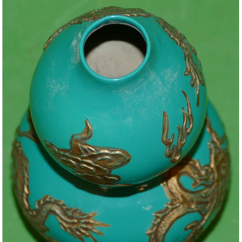 220 - An Oriental Gourd Vase on green ground having raised gilt dragon decoration, 17cm high.