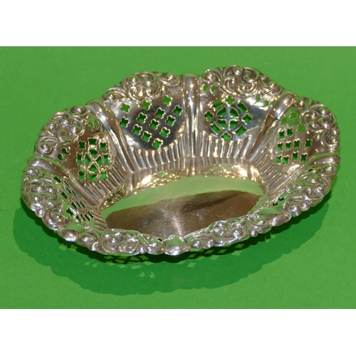 313 - An Edward VII Oval Silver Sweet Meat Dish having crinkled rim with embossed scroll decoration, pierc... 