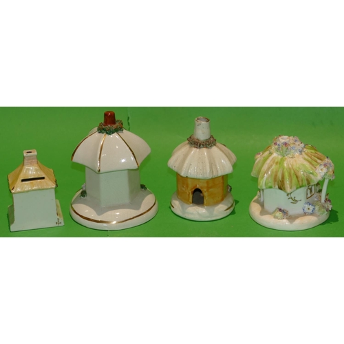 41 - A China Money Box in form of a cottage, 9cm high and 3 china round pastel burners in form of cottage... 