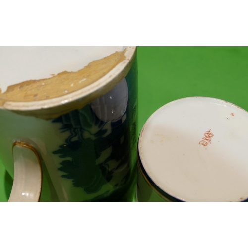 46 - A 19th Century Derby Mug on white and blue ground having hand painted rose, leaf and gilt decoration... 