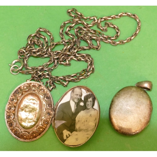 531 - An Oval Silver Locket (embossed front pushed in), with guard chain, also an oval (part missing to fr... 