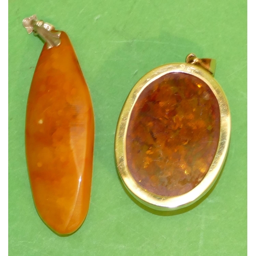 540 - A 9ct Gold Oval Amber Drop Pendant, also another amber drop pendant (2).