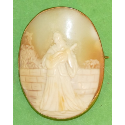 541 - An Oval Cameo Brooch in form of a lady standing next to a wall playing a musical instrument, 4cm hig... 