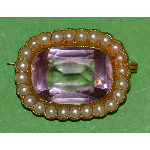 542 - A Rectangular Brooch set with amethyst, surrounded by half pearls, 2.5cm wide.