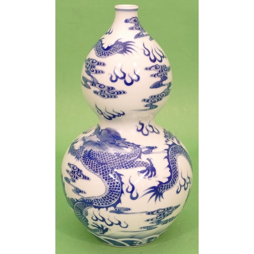 66 - An Oriental Blue and White Gourd Vase having dragon decoration, 24cm high.