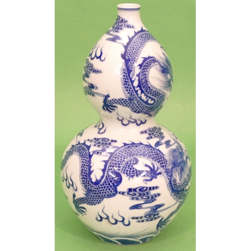 66 - An Oriental Blue and White Gourd Vase having dragon decoration, 24cm high.