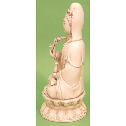 68 - An Oriental Bland-de-chine Figure of a seated goddess, 26cm high.