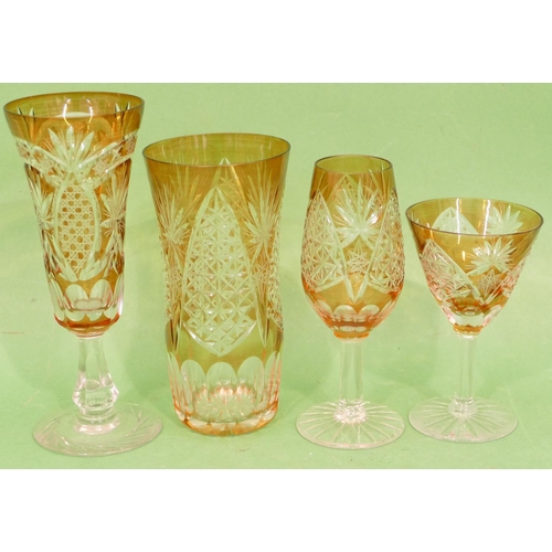 85 - An Amber and Clear Cut Glass Suite of Drinking Glasses, comprising 10 x round trumpet shaped champag... 