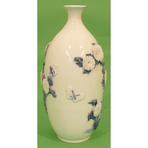 109 - An Oriental Round Bulbous Thin Necked Trumpet Shaped Vase on white ground having raised blue and whi... 