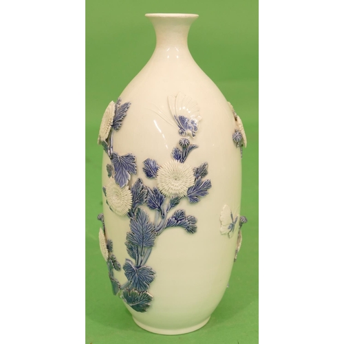 109 - An Oriental Round Bulbous Thin Necked Trumpet Shaped Vase on white ground having raised blue and whi... 