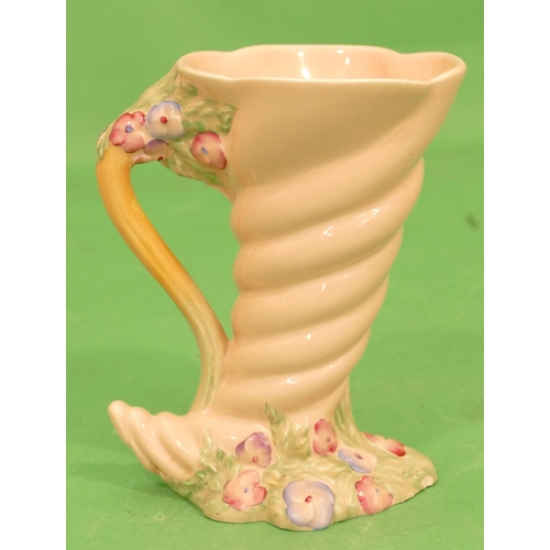 114 - A Clarice Cliff Shell Shaped Jug on pink ground with raised multicoloured floral and leaf decoration... 