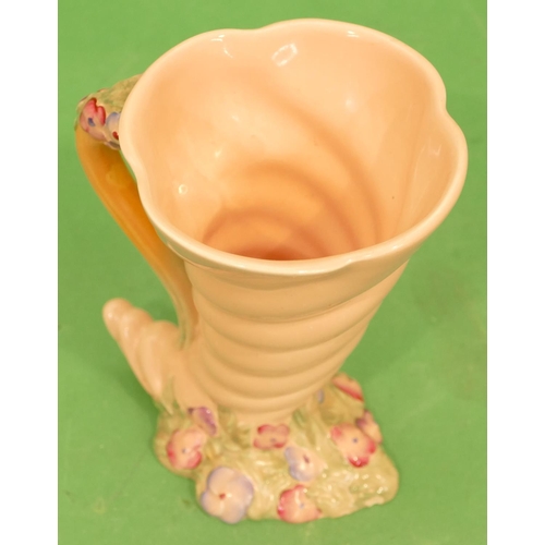 114 - A Clarice Cliff Shell Shaped Jug on pink ground with raised multicoloured floral and leaf decoration... 