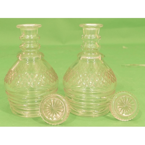 125 - A Pair of Heavy Cut Glass Round Bulbous Decanters having mushroom shaped stoppers, with ringed necks... 