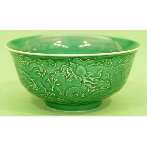 149 - An Oriental Round Trumpet Shaped Bowl on green ground with raised dragon decoration, 15.5cm diameter... 