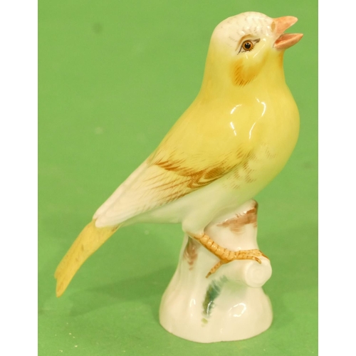 174 - A Meissen Figure of a perched yellow canary (tail wing restored) 11cm high.