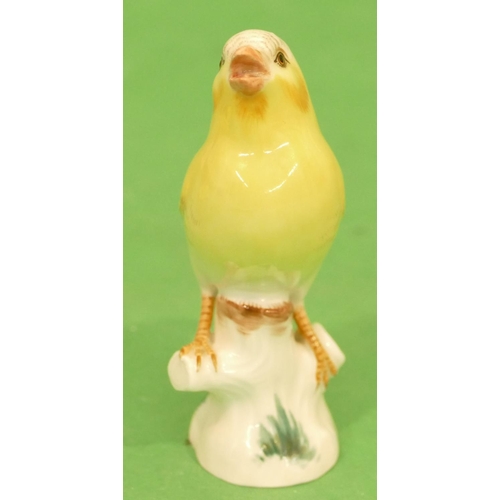 174 - A Meissen Figure of a perched yellow canary (tail wing restored) 11cm high.