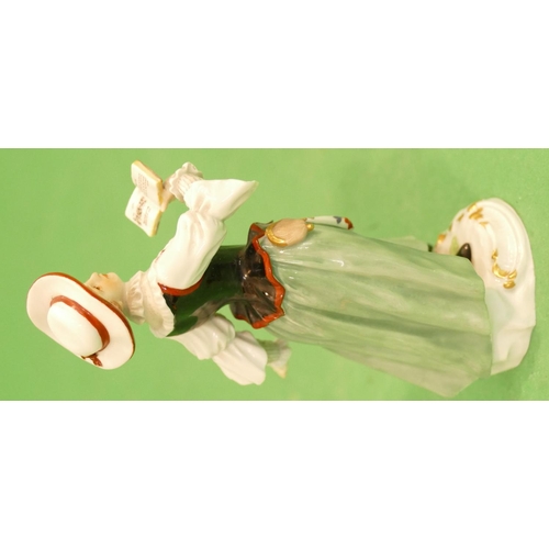 176 - A Meissen Figure of a young lady walking and  reading a book (left hand restored) 13.5cm high.