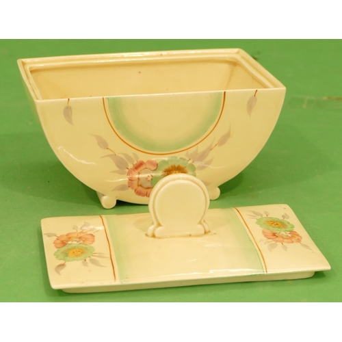 202 - A Clarice Cliff Half Round Lidded Tureen on cream ground with multicoloured floral and leaf decorati... 