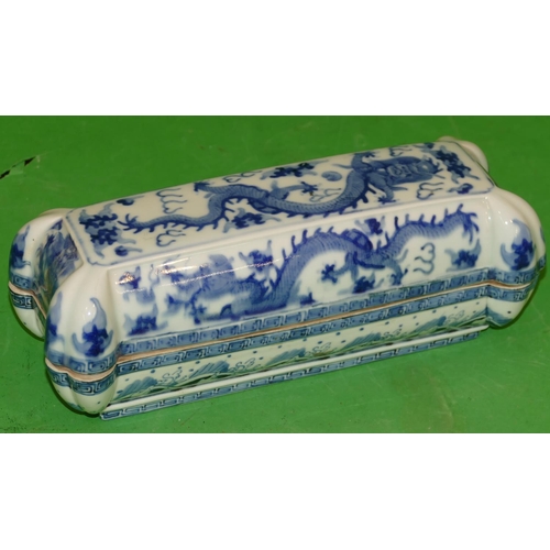 215 - An Oriental Blue and White Rectangular Shaped Lidded Box having all over dragon decoration, 28cm wid... 