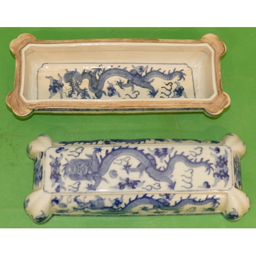 215 - An Oriental Blue and White Rectangular Shaped Lidded Box having all over dragon decoration, 28cm wid... 