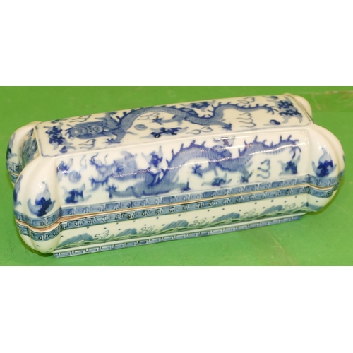 215 - An Oriental Blue and White Rectangular Shaped Lidded Box having all over dragon decoration, 28cm wid... 