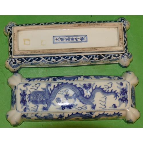 215 - An Oriental Blue and White Rectangular Shaped Lidded Box having all over dragon decoration, 28cm wid... 