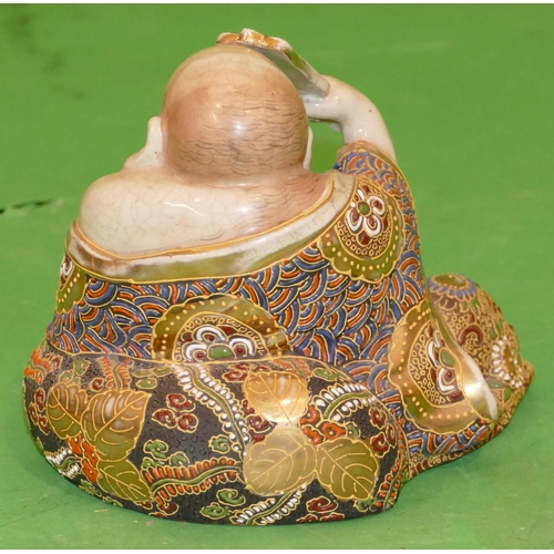 216 - A Satsuma Figure of a seated Buddha having multicoloured robe, 12cm high.