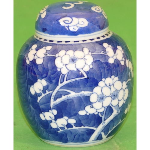 220 - A Small Oriental Round Bulbous Lidded Ginger Jar on blue and white ground having branch and blossom ... 