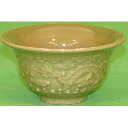 223 - An Oriental Round Trumpet Shaped Bowl on green ground with raised dragon decoration, 12cm diameter.