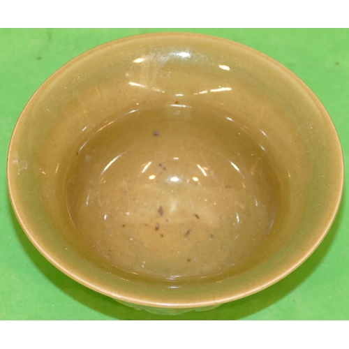 223 - An Oriental Round Trumpet Shaped Bowl on green ground with raised dragon decoration, 12cm diameter.