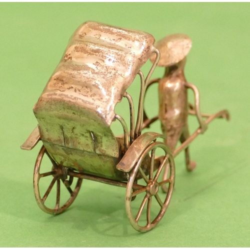 304 - A Continental Silver Coloured Metal Miniature Rickshaw, 8.5cm long, 1oz.