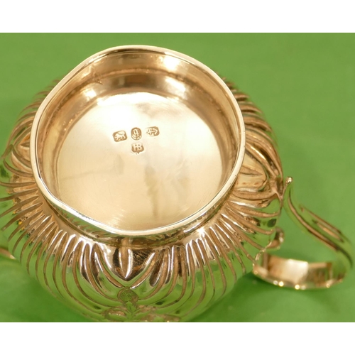 323 - A Victorian Small Silver Round Bulbous Shaped Cream Jug having embossed shell decoration, Birmingham... 