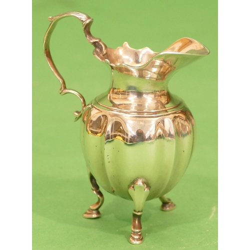 333 - A George V Silver Bulbous Shaped Cream Jug having scroll handle on splayed legs with hoof feet, Birm... 