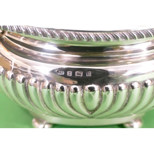 345 - An Edward VII 3 Piece Silver Tea Service having half embossed reeded decoration, on bun feet compris... 