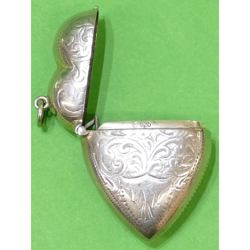 366 - A 925 Continental Silver Vesta Case in form of a heart having hinge lid with engraved scroll decorat... 