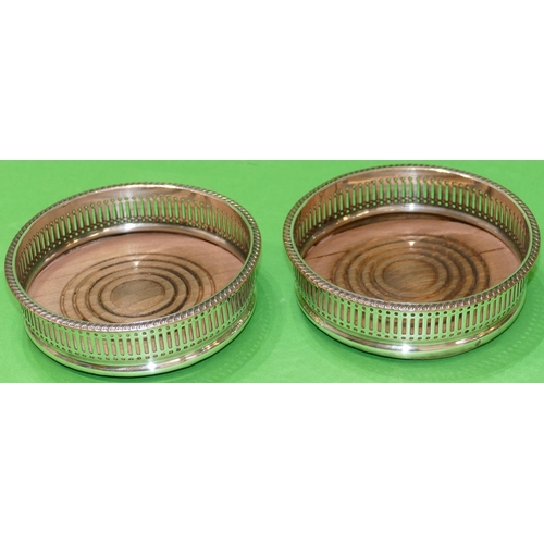 372 - A Pair of Silver Plated Wine Coasters having gadroon rims, wooden centres, 13.8cm diameter.