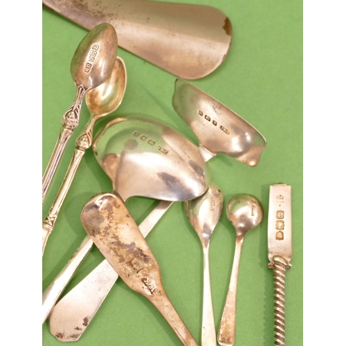 386 - A London Silver Child's Pusher and egg spoon, a pair of silver sugar tongs, a silver teaspoon, a sil... 